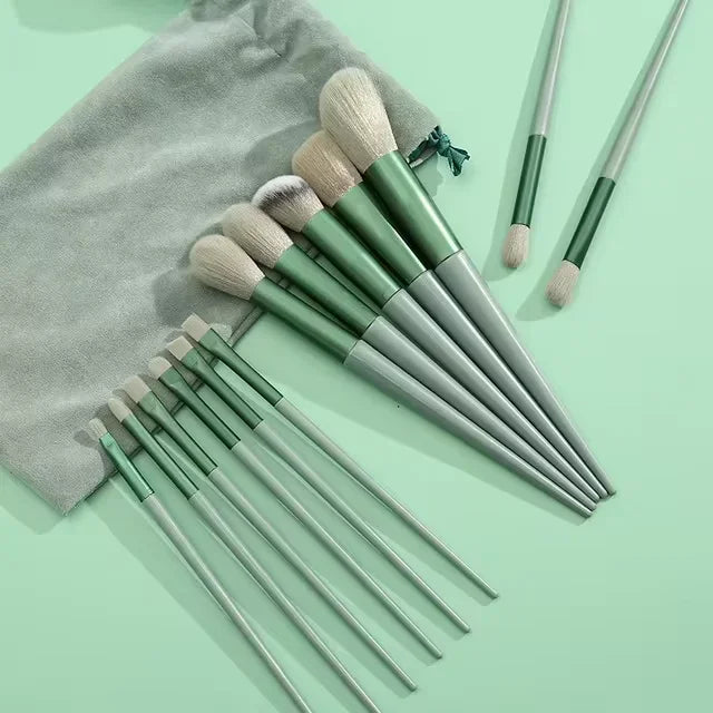 Luxury makeup brush set with green handles and soft bristles on a mint green background