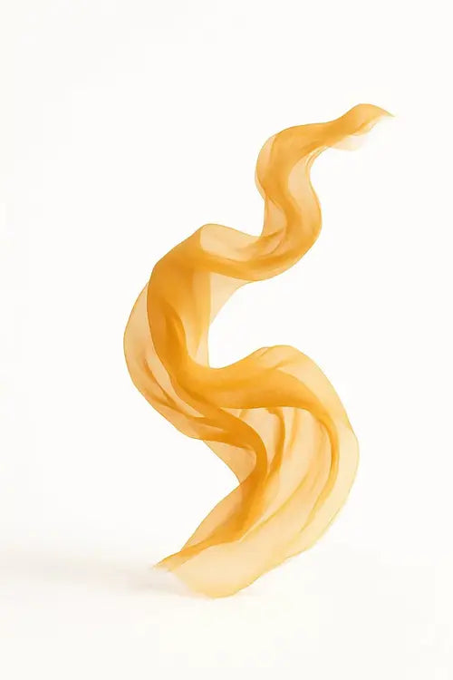 Sheer yellow silk scarf floating on white background
