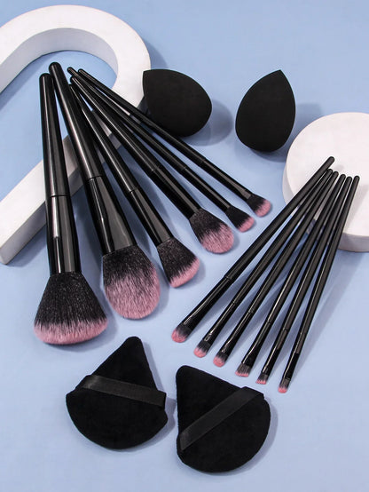 Luxury soft makeup brush set with black handles, pink bristles, sponges, and powder puffs on blue background