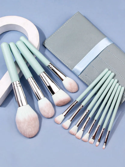 Luxury soft makeup brush set of 11 with light blue handles and matching case on blue background