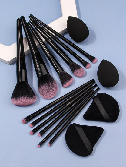 Luxury soft makeup brush set with black handles, blending sponges, and powder puffs on blue background