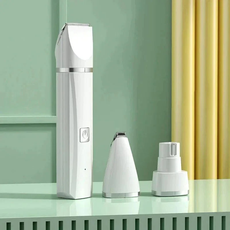 White all-in-one pet grooming kit with three attachments on a mint green table.