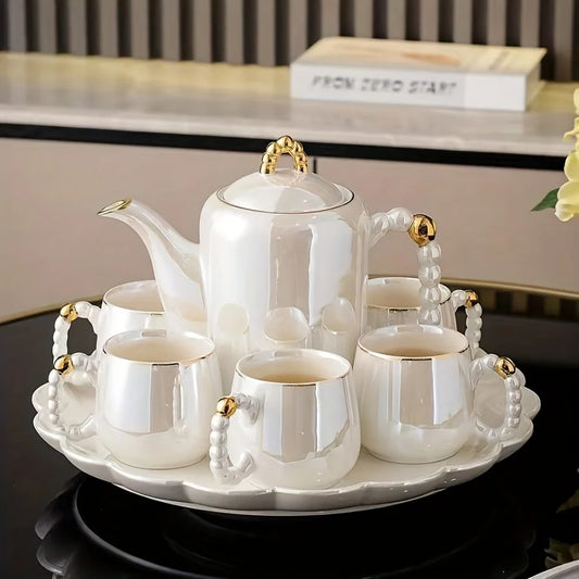 Pearl glazed European style porcelain tea set with gold accents, teapot and six cups on tray
