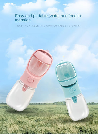 Portable dog water bottles with integrated food storage in pink and blue, outdoor grassy field background