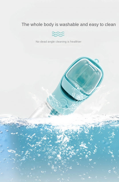 Blue portable dog water bottle with food storage partially submerged in water, splash effect, washable and easy to clean