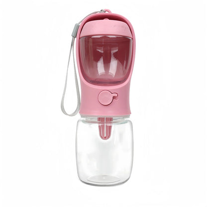 Pink portable dog water bottle with built-in food storage and wrist strap for outdoor use