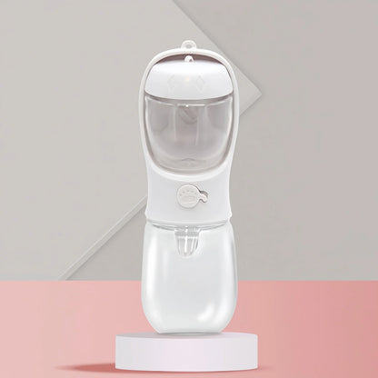 White portable dog water bottle with food storage, featuring a paw-print button, on a pink and gray geometric background