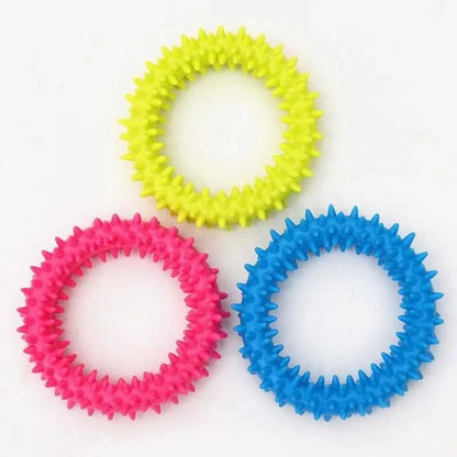 Three colorful rubber chew rings for small dogs in yellow, pink, and blue with textured spikes