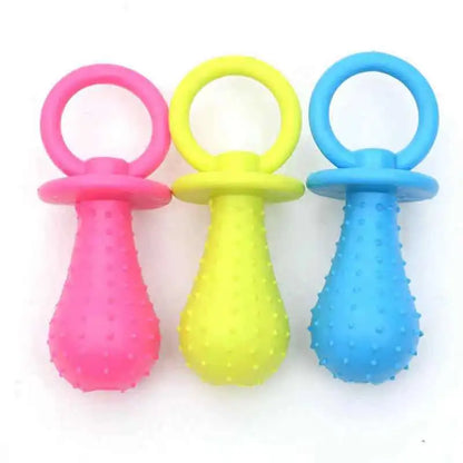 Set of three colorful rubber resistance chew toys for small dogs in pink, yellow, and blue with textured surface