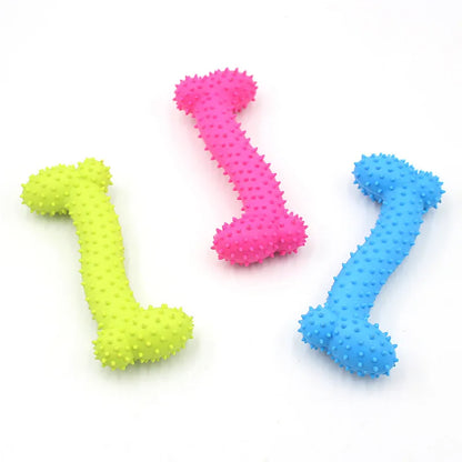 Three colorful rubber dog chew toys shaped like bones with textured spikes in yellow, pink, and blue
