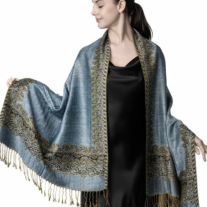 Woman wearing elegant blue pashmina shawl with gold paisley border and fringe detailing