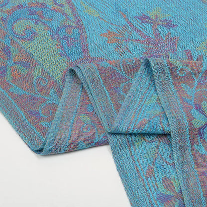 Blue paisley jacquard fabric with intricate floral patterns on a white background