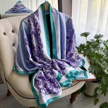 Purple floral silk scarf with teal border draped on armchair by window and plant