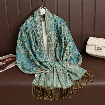 Elegant blue and gold floral paisley shawl with fringe detail on brown bench