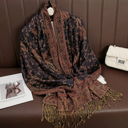 Paisley patterned black and gold pashmina shawl with fringe on brown sofa