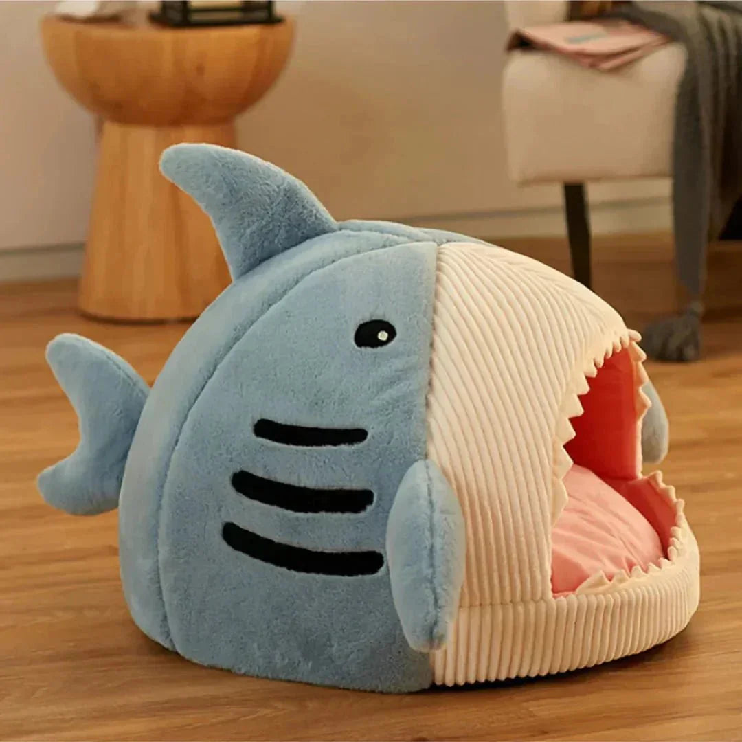 Shark-shaped pet bed with plush material for cats and small dogs on wooden floor
