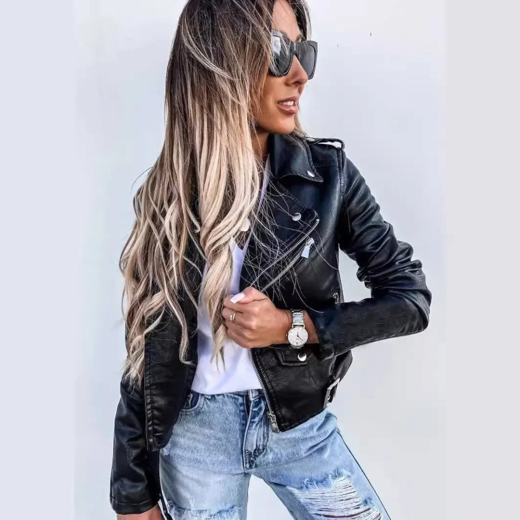 Woman in black luxury slim fit PU jacket, distressed jeans, sunglasses, and watch