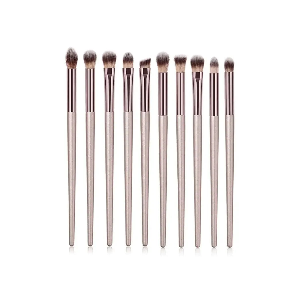 Champagne luxury makeup brush set with soft bristles and metallic handles, arranged in a row.