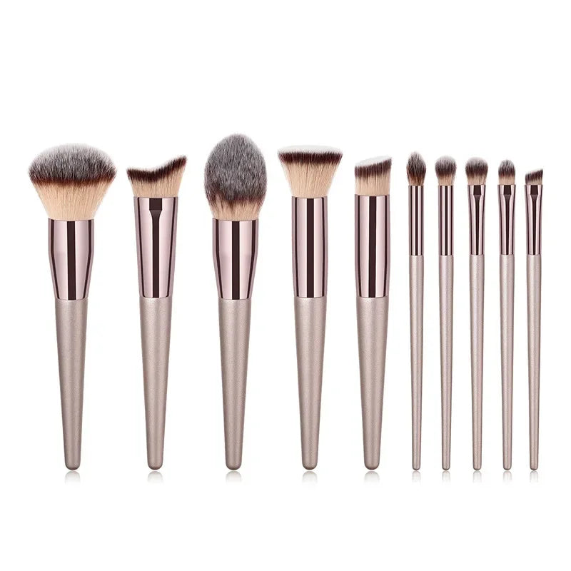 Champagne luxury makeup brush set with nine brushes, sleek metallic handles, white background