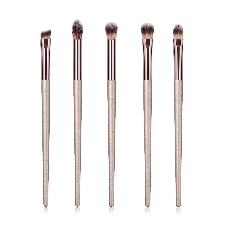 Champagne luxury makeup brush set with five brushes, rose gold handles on white background