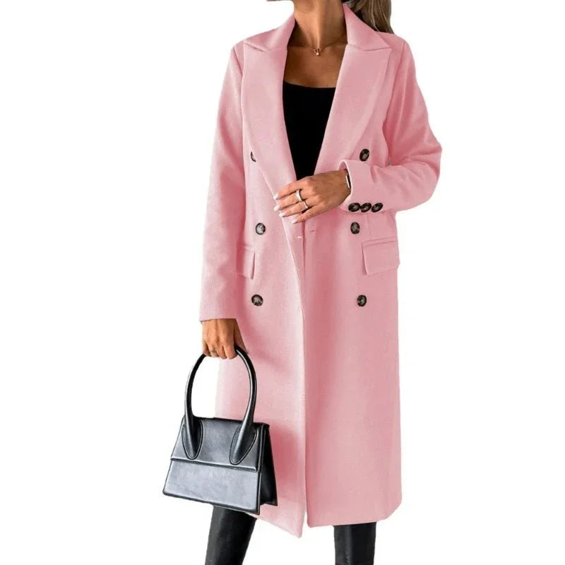 Woman wearing pink wool trench coat and holding black handbag, white background