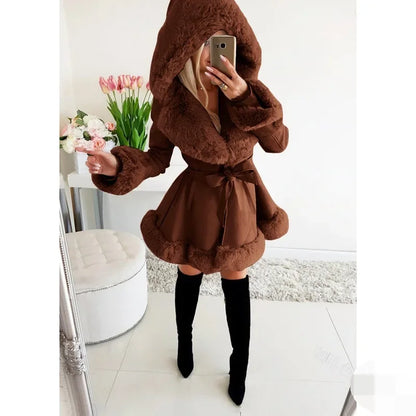 Woman wearing brown hooded faux fur parka with a waist belt, paired with black thigh-high boots indoors