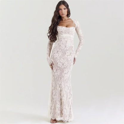 Woman wearing an ivory lace luxury ball gown with long sleeves, standing against a plain light background