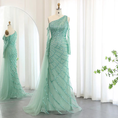 Elegant mint green luxury beaded mermaid gown on mannequin with sheer one-shoulder design