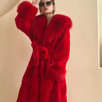 Woman wearing luxury red faux fur trench coat with large collar and belt, posing indoors