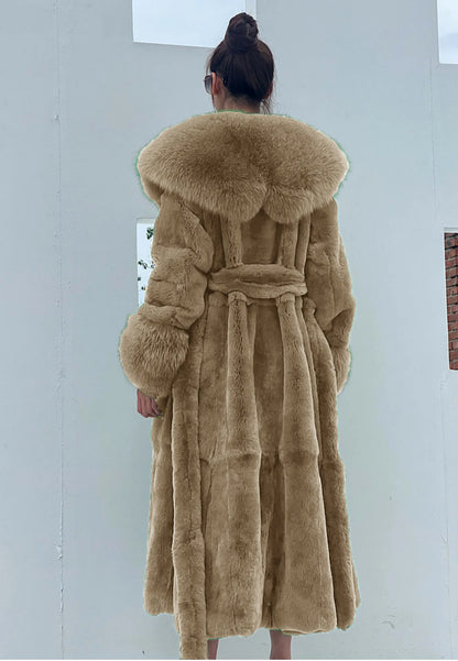 Back view of woman wearing luxury beige faux fur trench coat with wide collar and belt indoors