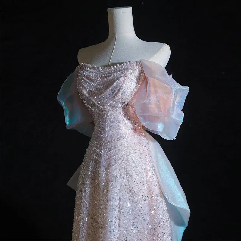 Luxury pearl and sequin evening gown with elegant bow detail, high-end formal dress for prom, parties, and special events