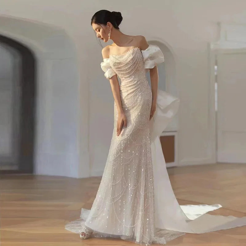 Luxury pearl and sequin evening gown with elegant bow detail, high-end formal dress for prom, parties, and special events