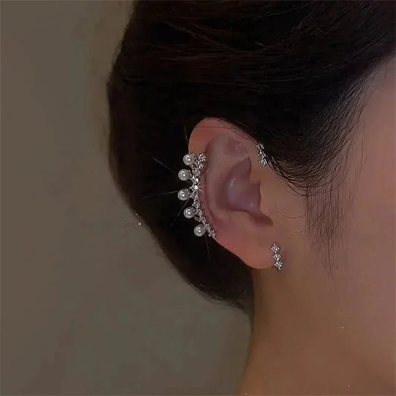 Luxury pearl zircon ear cuff on woman's ear, elegant jewelry accessory