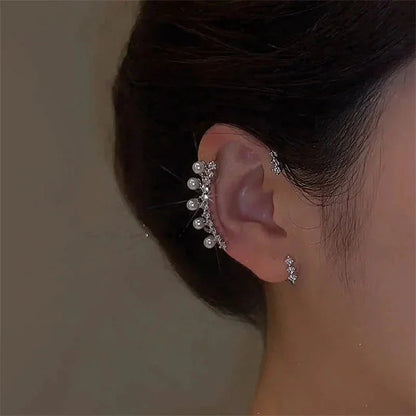 Luxury pearl zircon ear cuff on woman's ear, elegant jewelry accessory