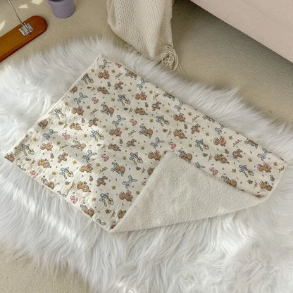 Luxury pet blanket with cute animal prints, soft cozy fabric on white faux fur rug