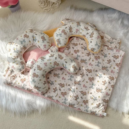 Luxury pet blanket and pillow set with cute teddy bear and balloon print on soft fabric, placed on white faux fur