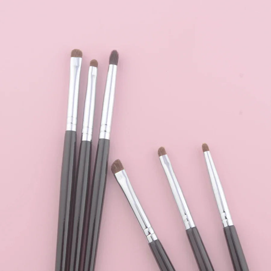 Set of luxury pony hair eyeshadow brushes with silver ferrules on pink background