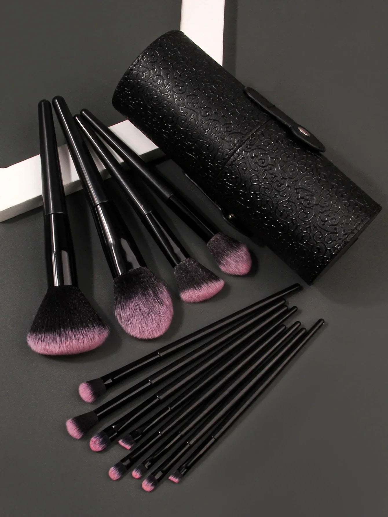 Luxury soft makeup brush set with black handles, pink bristles, and patterned black case