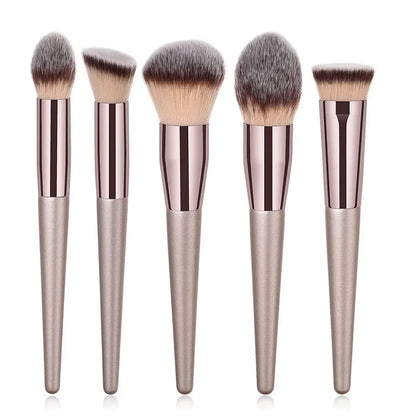 Champagne luxury makeup brush set with five metallic brushes on a white background