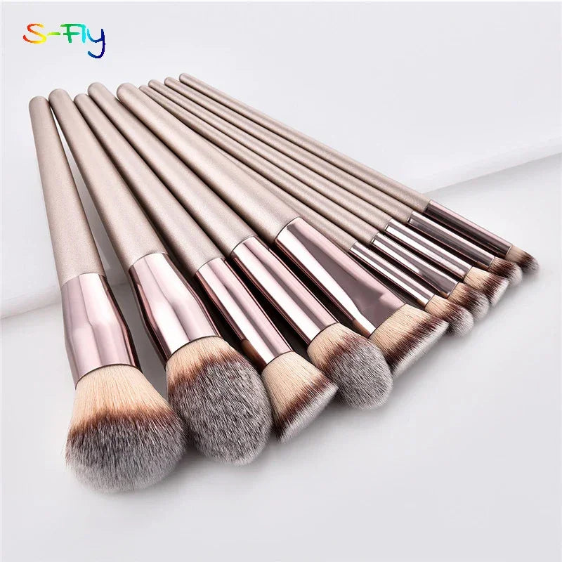 Champagne luxury makeup brush set with soft bristles and metallic handles on white background.