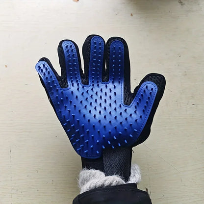 Blue pet grooming glove with rubber bristles on hand against light surface for gentle deshedding