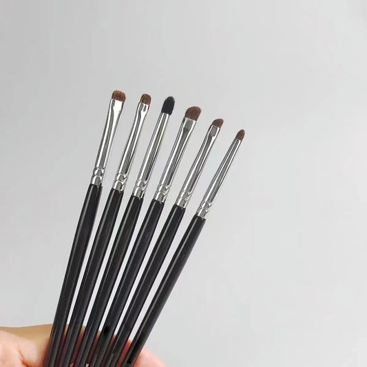 Pony hair eyeshadow brushes set with black handles on a light background