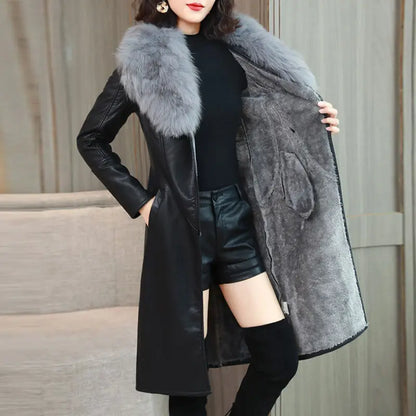Woman wearing long black PU leather coat with gray faux fur collar and soft inner lining, styled with black shorts and boots