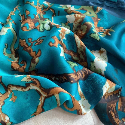 Teal floral patterned chiffon fabric with brown branches and white flowers