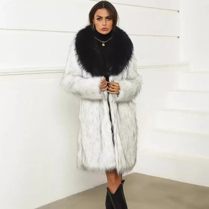 Woman wearing a thick white faux fox fur coat with a large black collar, styled with black ankle boots in a modern minimal setting