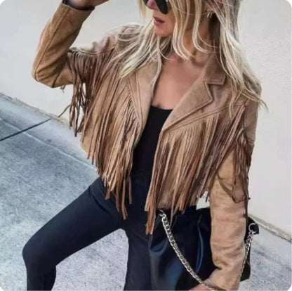 Woman wearing vintage suede fringe jacket, black pants, and sunglasses outdoors