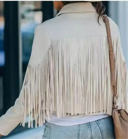 Woman wearing vintage beige suede fringe jacket and jeans outdoors