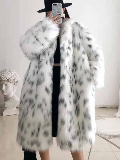 Person wearing white faux fur winter coat with black spots, black hat, indoors with classical bust sculpture and chair